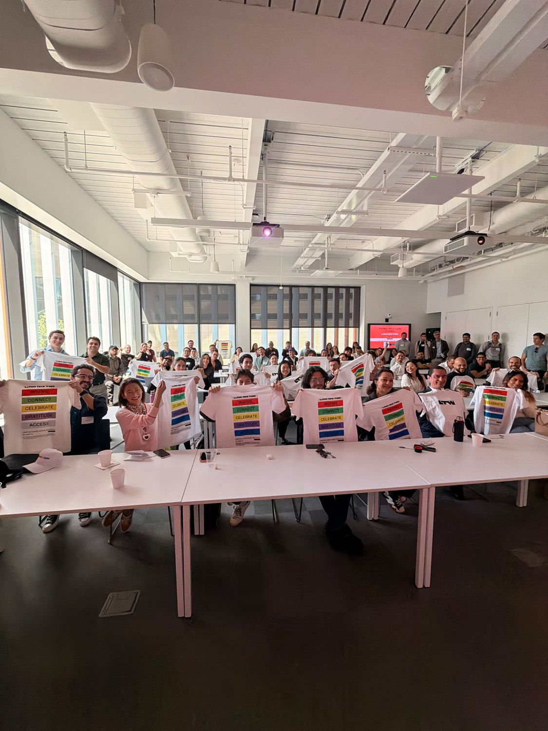 Latino Tech Week attendees holding up Colectivo t-shirts in New York