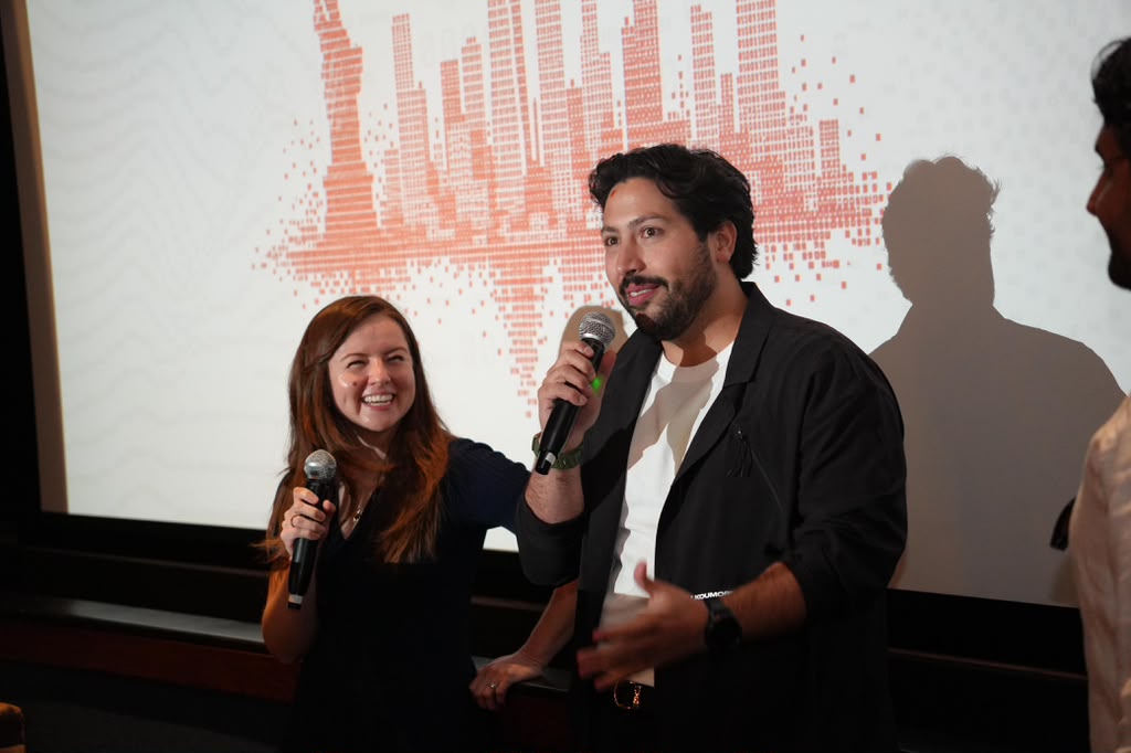 Hosts opening a Colectivo night on stage in New York